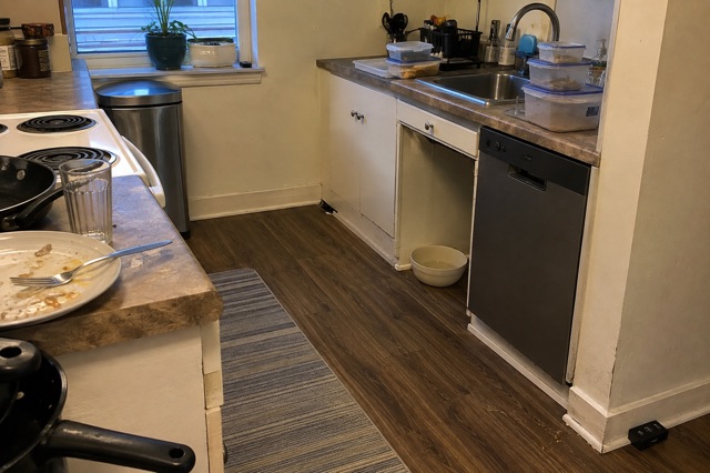 A lived-in kitchen set up to remove food and water sources and monitor indoor pests